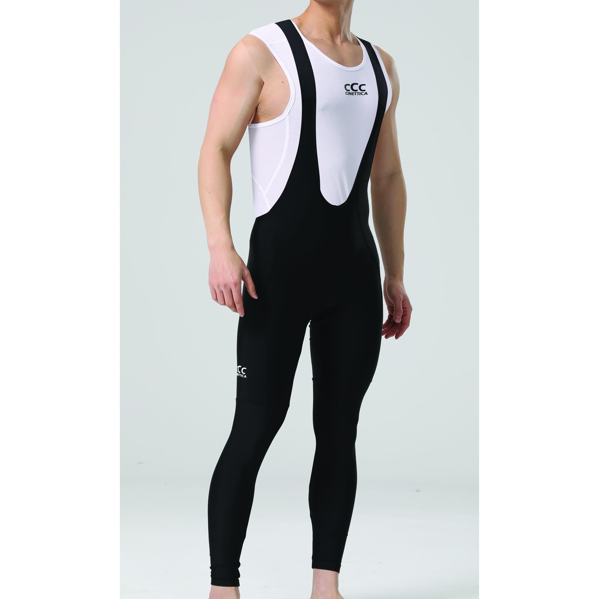 Man wearing black Cinettica Ariston long bibknicks with white mesh bib straps and a white undershirt.