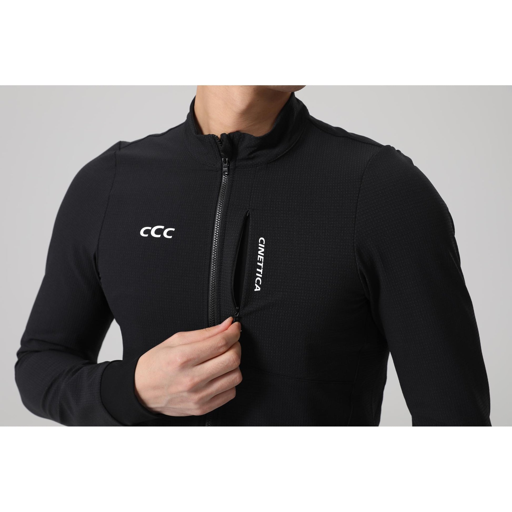 Black Cinettica Vincita wind jacket with full zip, textured fabric, and vertical zippered pocket.