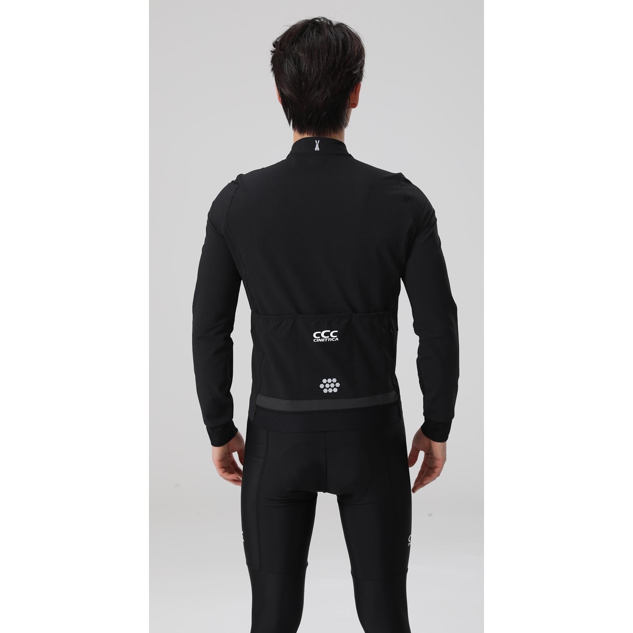 Cinettica Vincita black wind jacket with reflective details, shown from the back on a model.